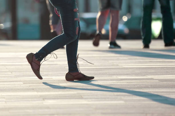walking women legs in backlight sunlight