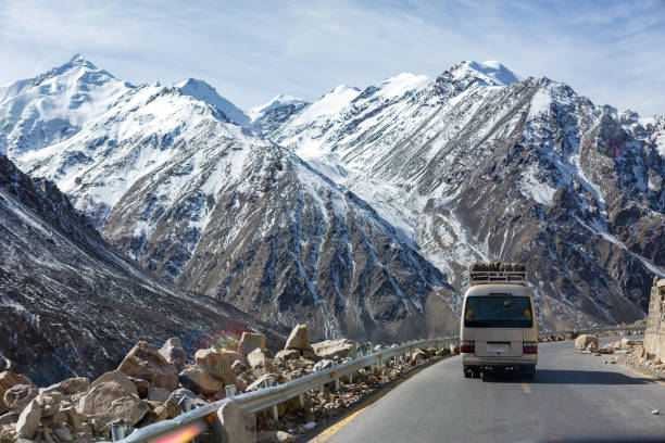 tourist bus with scenery of the snow covered lands in autumn on the way to Khunjerap Pass,Pakistan-China Border, Highest Border crossing in the world,Gilgit-Baltistan,northern Pakistan tourist bus with scenery of the snow covered lands in autumn on the way to Khunjerap Pass,Pakistan-China Border, Highest Border crossing in the world,Gilgit-Baltistan,northern Pakistan karakoram range stock pictures, royalty-free photos & images