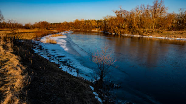 istock River and meadow and dry grass on a winter evening 1204369664