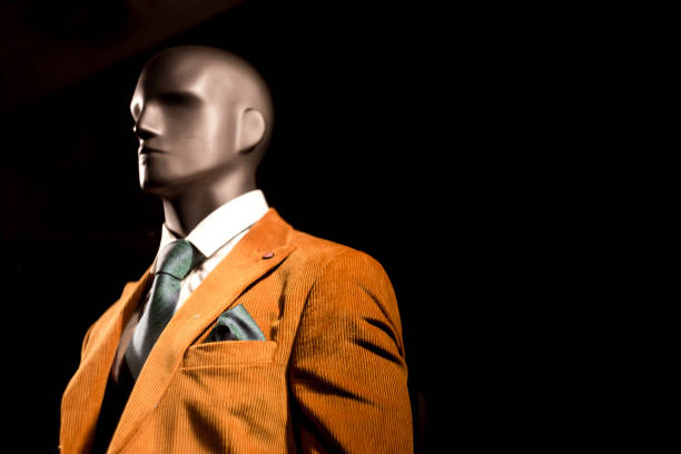 istock Plastic male mannequin at night in clothing store window 1204371702