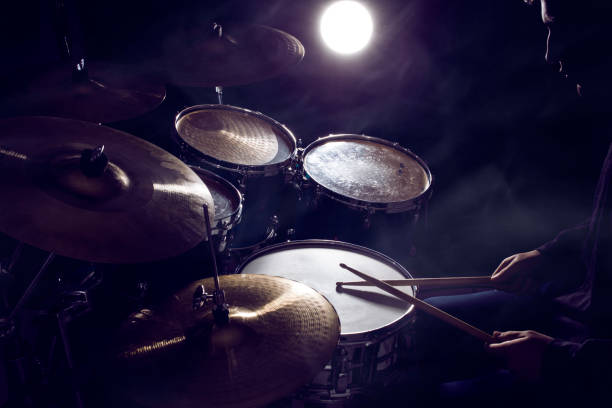 istock The man is playing drum set in low light background 1204371968