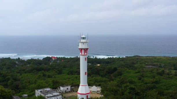 istock White tower lighthouse on a large island, top view 1204372816