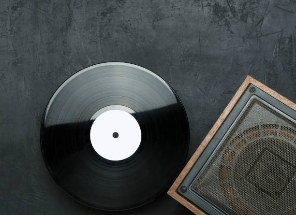istock Top view of vintage music column and vinyl record on the black surface.Empty space for text 1204373146