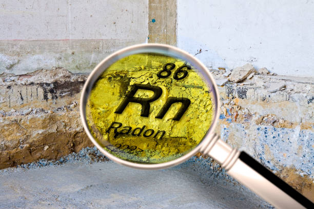 Preparatory stage for the construction of a ventilated crawl space in an old brick building - Searching gas radon concept image seen through a magnifying glass. stock photo