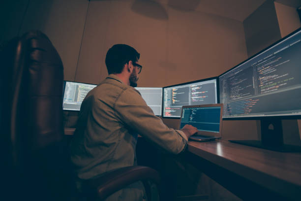 istock Profile side view of his he nice senior experienced skilled smart clever brunet guy providing tech support clients service desk in dark beige room workplace station indoors 1204373967