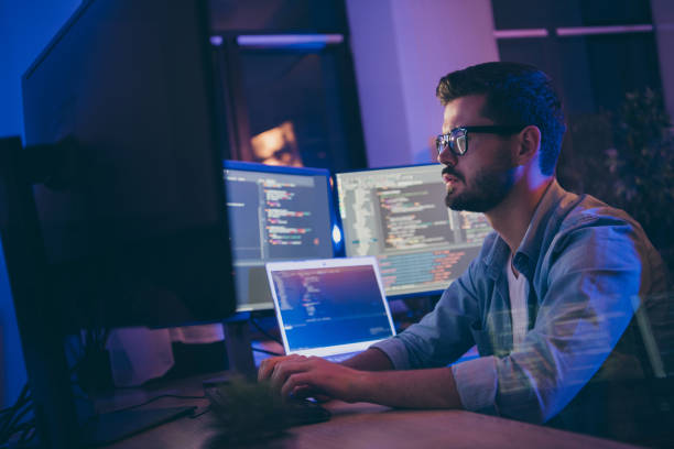 Profile side view portrait of his he nice attractive skilled focused serious guy writing script ai tech support devops creating digital solution front-end in dark room workplace station indoors Profile side view portrait of his he nice attractive skilled focused serious, guy writing script ai tech support devops creating digital solution front-end in dark room workplace station indoors programmer stock pictures, royalty-free photos & images