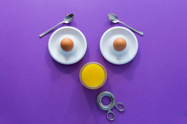 Fun breakfast concept with abstract astonished human face made of breakfast items on purple background