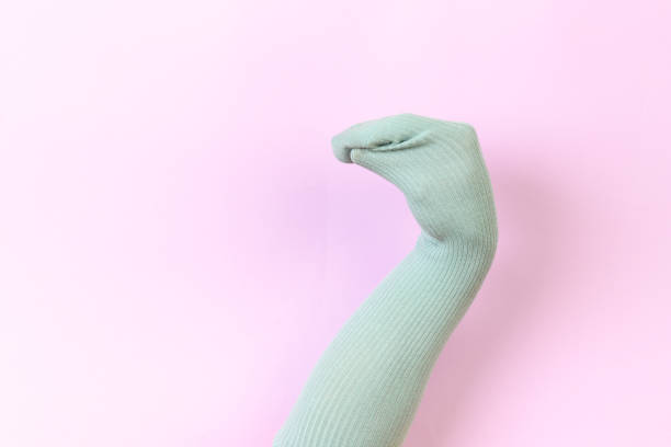 istock funny doll sock on pink background, hand theater 1204375374