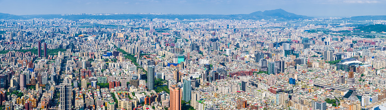 Aerial panorama over the highrise housing, skyscrapers and crowded cityscape of central Taipei, Taiwan’s vibrant capital city.