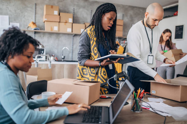 istock Diverse group of people arranging customers orders for drop shipping 1204376414