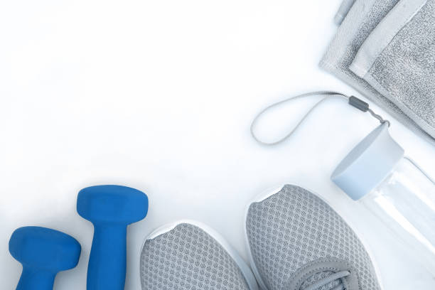 istock Running shoes, dumbbells water bottle towel on white background 1204377923