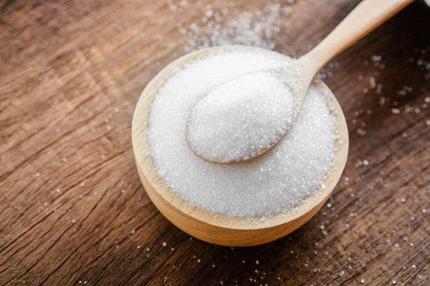 istock sugar in bowl with spoon on wooden table closeup 1204379022