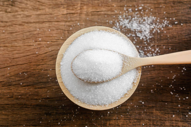 istock sugar in bowl with spoon on wooden table closeup 1204379038