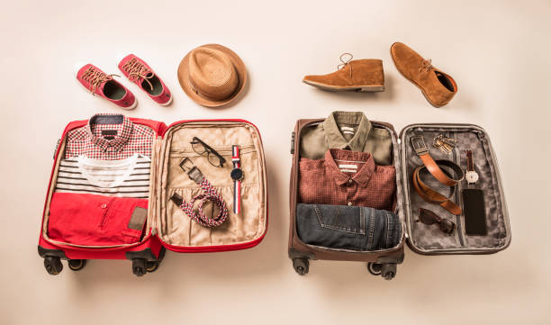 istock Two suitcases (baggage) with different style men's clothing 1204379420