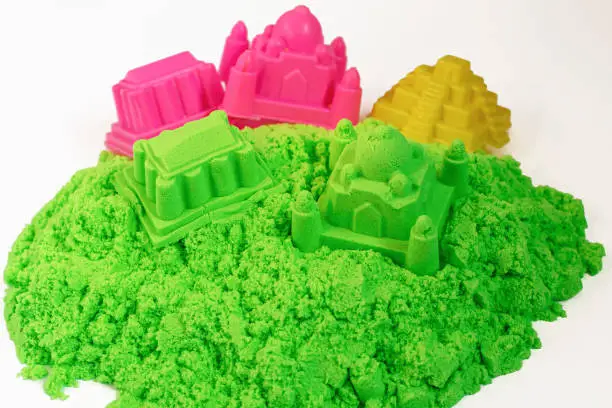 Photo of Kinetic sand of green color. Fine motor skills, creativity, games for children, entertainment