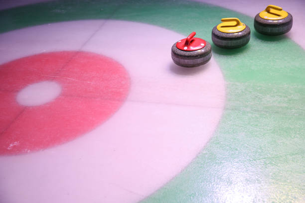 istock curling stones on ice near the home 1204379488