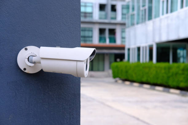 istock Closeup of CCTV camera on a wall. 1204379547
