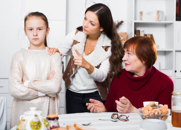 istock Offended little while mom and granny scolding her 1204380946