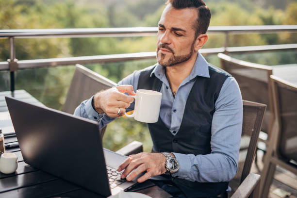 istock One mature business man sitting on the restaurant terrace 1204381075