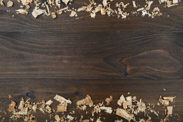 istock light wood shavings on dark wooden background 1204381352