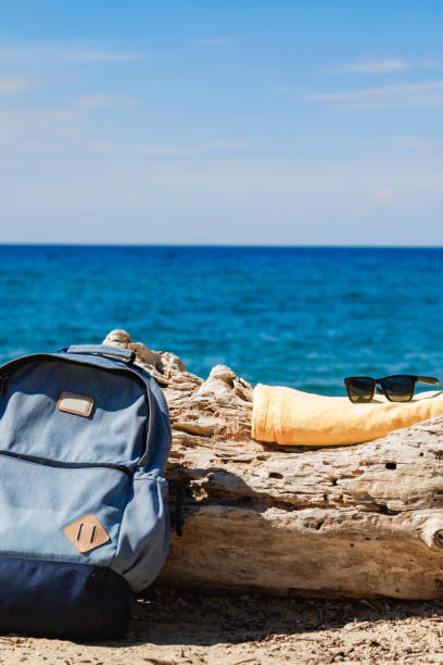 istock Tourist rucksack on a sandy tropical beach. 1204381438