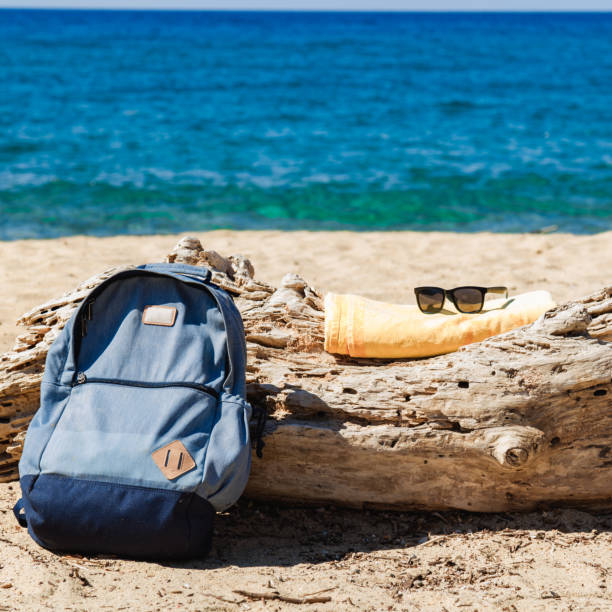 istock Tourist rucksack on a sandy tropical beach. 1204381476