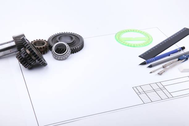istock backdrop with drafting accessories, drafting paper and metal gears 1204382747