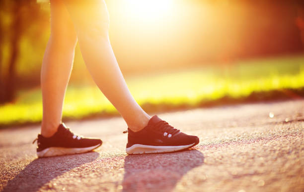 istock Young woman running in the park 1204383380