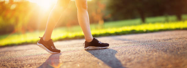 istock Young woman running in the park 1204383474