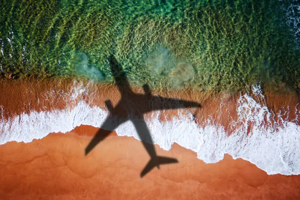 Photo of airplane over the beach for the destinations