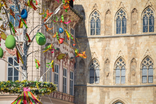 Easter tree with ribbon and eggs decorations historical buildings in the background, Old town square, Prague, Czech Republic, copy space