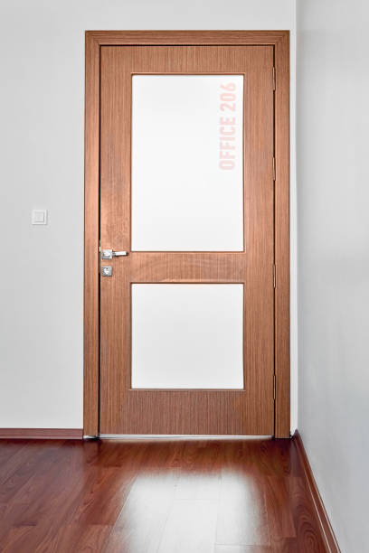 Brown office door with frosted glass Brown office door with frosted glass in an office frosted glass door office stock pictures, royalty-free photos & images