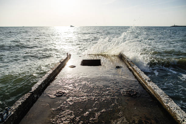 Sea waves beat on concrete Persian on a sunny day. Relax.