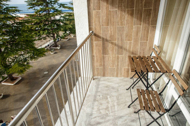 istock Wooden chairs and table on open seaside balcony. 1204390731