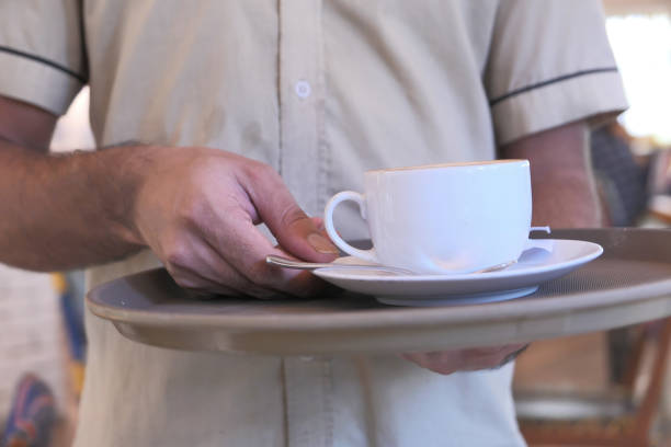 istock closeup of man serving tea at cafe 1204391002