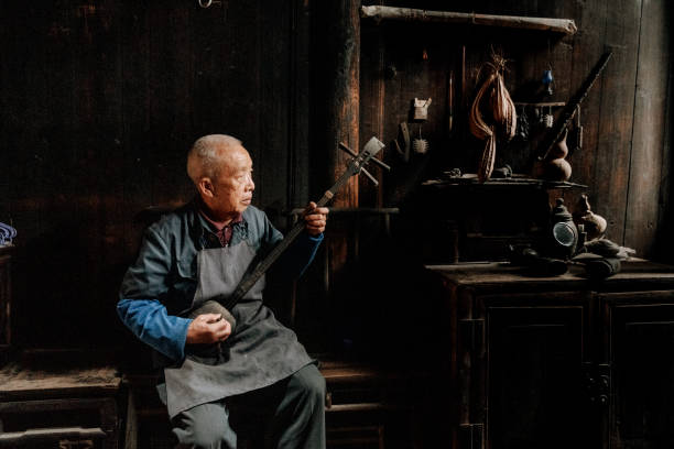 istock Chinese senior man playing longneck lute 1204393092