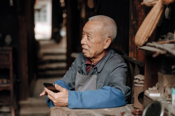 istock Chinese senior man using mobile phone 1204393134