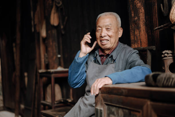 istock Chinese senior man using mobile phone 1204393159