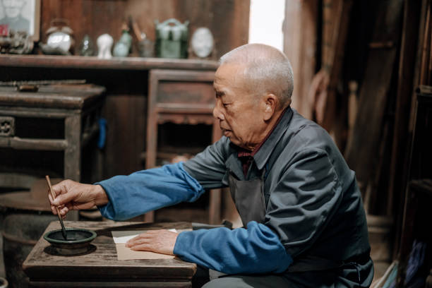 istock Chinese senior man writing chinese calligraphy 1204393217