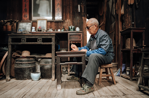 Chinese senior man using mobile phone