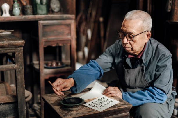 istock senior man in China writing chinese calligraphy 1204393375