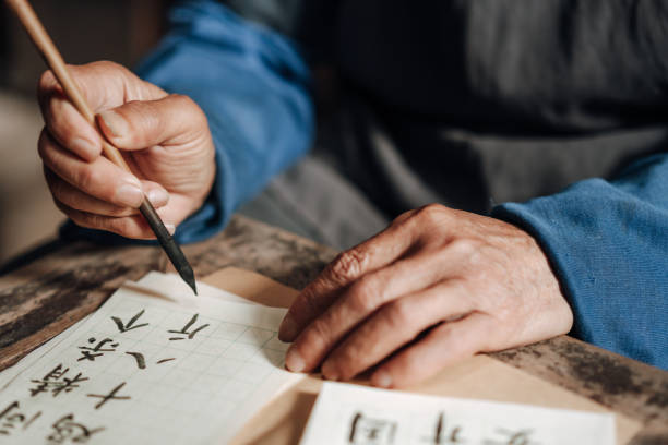 istock Chinese senior man writing chinese calligraphy 1204393488