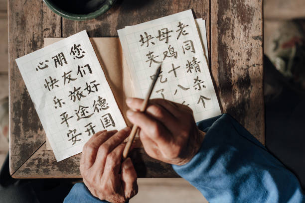 istock Chinese senior man writing chinese calligraphy 1204393542