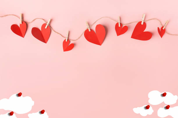istock Valentine's Day background. Hearts,Clouds on pastel pink background. Valentines day concept. Flat lay, top view, copy space. 1204395252