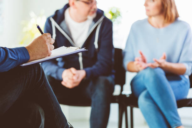 istock Troubled couple talking with psychotherapist 1204396472