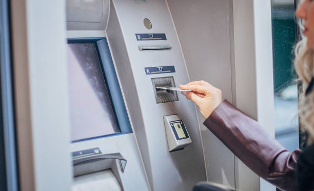 istock Young teenage girl using ATM machine 1204396939