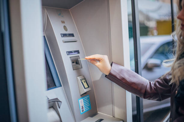 istock One young teenage girl using ATM machine 1204396964
