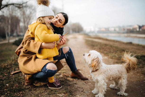 istock Mother resting near river with daughter 1204397752