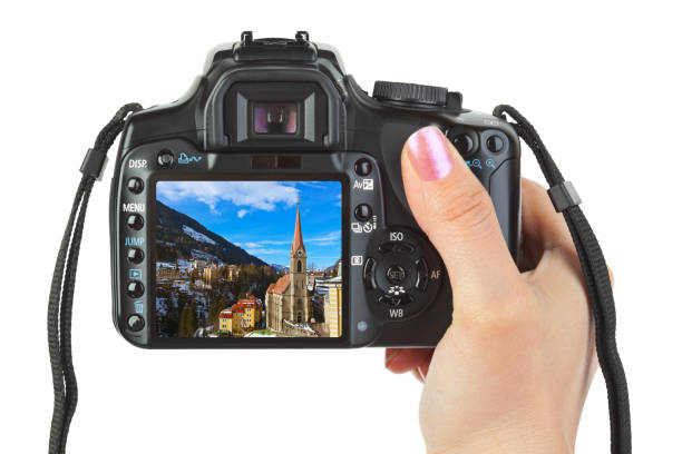 istock Camera in hand and winter Austria view 1204398184
