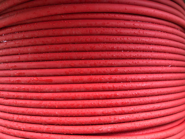 istock red coiled electrical cable on the wooden spool 1204398535